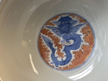 A Chinese blue, white and iron-red 'dragon' bowl and a famille rose 'immortals' bowl, Jiaqing and Wanli mark, 19th C.