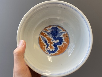 A Chinese blue, white and iron-red 'dragon' bowl and a famille rose 'immortals' bowl, Jiaqing and Wanli mark, 19th C.