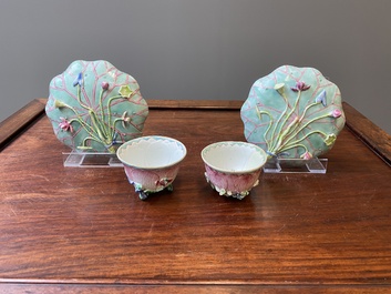 A pair of Chinese relief-decorated famille rose 'lotus' cups and saucers with a scholar and his servant, Yongzheng