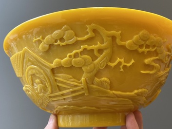 A pair of Chinese yellow Beijing glass bowls with figures in mountainous landscapes, 19/20th C.