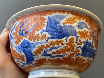 A Chinese blue, white and iron-red 'dragon' bowl and a famille rose 'immortals' bowl, Jiaqing and Wanli mark, 19th C.