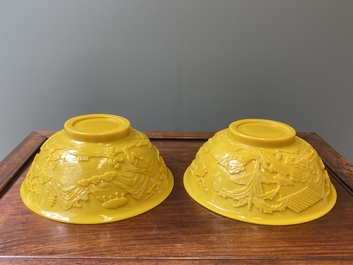 A pair of Chinese yellow Beijing glass bowls with figures in mountainous landscapes, 19/20th C.