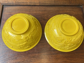 A pair of Chinese yellow Beijing glass bowls with figures in mountainous landscapes, 19/20th C.