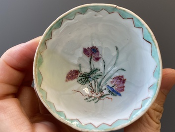 A pair of Chinese relief-decorated famille rose 'lotus' cups and saucers with a scholar and his servant, Yongzheng