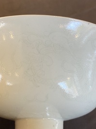 A Chinese monochrome white-glazed stem cup with anhua dragon design, Qianlong mark, 18/19th C.