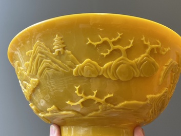 A pair of Chinese yellow Beijing glass bowls with figures in mountainous landscapes, 19/20th C.