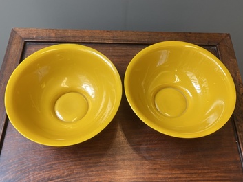 A pair of Chinese yellow Beijing glass bowls with figures in mountainous landscapes, 19/20th C.