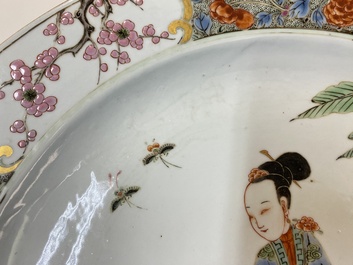 A Chinese famille rose dish with two ladies and a boy in a garden, Yongzheng