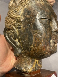 A Chinese brown-grey limestone head of Bodhisattva, probably Tang