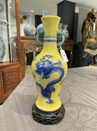 A Chinese blue and white yellow-ground 'dragon' vase with green-glazed handles on a jade-inset wooden stand, Jiaqing mark, 19/20th C.