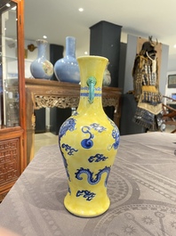 A Chinese blue and white yellow-ground 'dragon' vase with green-glazed handles on a jade-inset wooden stand, Jiaqing mark, 19/20th C.