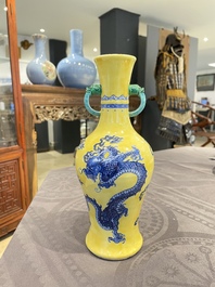 A Chinese blue and white yellow-ground 'dragon' vase with green-glazed handles on a jade-inset wooden stand, Jiaqing mark, 19/20th C.