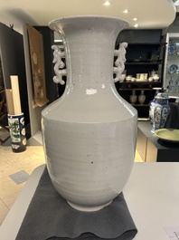 A Chinese white-glazed vase on wooden stand, 19th C.