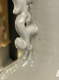 A Chinese white-glazed vase on wooden stand, 19th C.