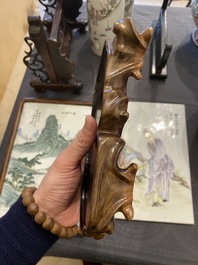 A Chinese monochrome brown-grey-glazed sculpture of a reclining water buffalo on wooden stand, 19th C.