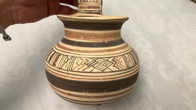 Two geometrical decorated Daunian pottery vessels and an olive press, Southern Italy, 6th/3rd C. b.C.