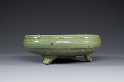 A Chinese Longquan celadon tripod censer on wooden stand, Yuan/Ming