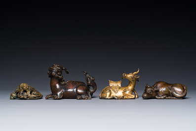 A group of four Chinese gilt bronze paper-weights, Ming/Qing