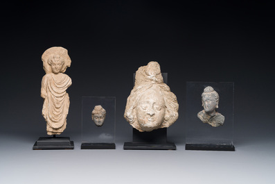 Two small Gandhara grey schist Bodhisattva heads, a stucco sculpture of Bodhisattva and a stucco female head, 1/4th C.