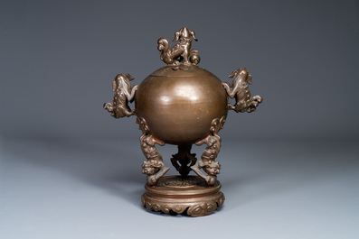 A large Chinese bronze censer and cover on stand decorated with six lions, 19th C.