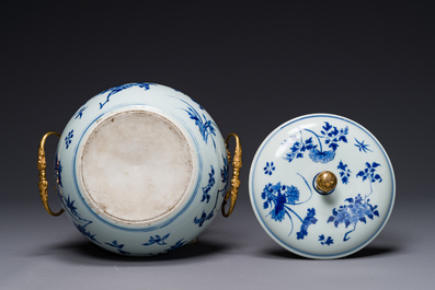 A Chinese blue and white covered bowl with floral design and gilt ...