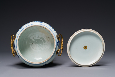 A Chinese blue and white covered bowl with floral design and gilt ...