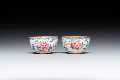 A pair of fine Chinese Canton enamel cups and three saucers with floral design, Yongzheng/Qianlong