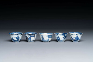 Thirteen Chinese blue and white saucers and twelve cups with figural design, Kangxi/Yongzheng