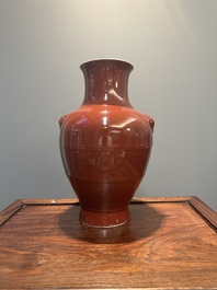 A Chinese monochrome red-glazed 'hu' vase, Qianlong mark, 19th C.