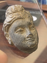 A Gandhara fragment of a stucco Sakyamuni head and a grey schist Bodhisattva head, 1/4th C.