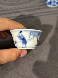 Thirteen Chinese blue and white saucers and twelve cups with figural design, Kangxi/Yongzheng