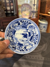 Thirteen Chinese blue and white saucers and twelve cups with figural design, Kangxi/Yongzheng