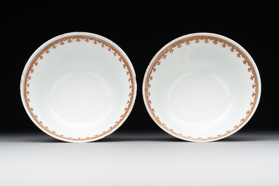 A pair of Chinese armorial famille rose cups and saucers with the arms of Tyndall for the English market and two monogrammed bowls, Qianlong