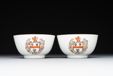 A pair of Chinese armorial famille rose cups and saucers with the arms of Tyndall for the English market and two monogrammed bowls, Qianlong