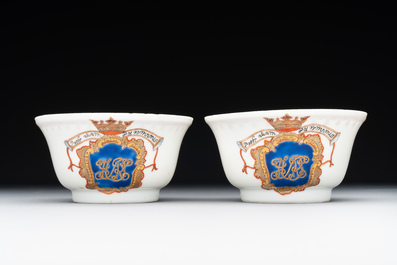 A pair of Chinese armorial famille rose cups and saucers with the arms of Tyndall for the English market and two monogrammed bowls, Qianlong