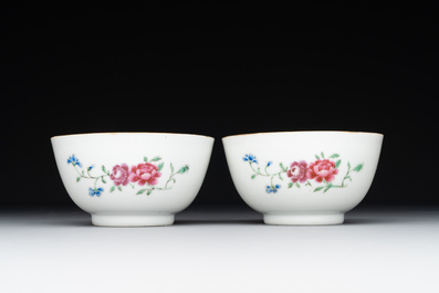 A pair of Chinese armorial famille rose cups and saucers with the arms of Tyndall for the English market and two monogrammed bowls, Qianlong