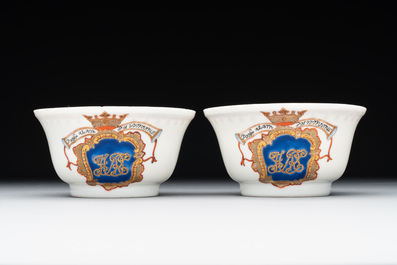 A pair of Chinese armorial famille rose cups and saucers with the arms of Tyndall for the English market and two monogrammed bowls, Qianlong