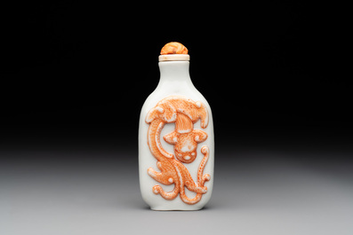 A Chinese moulded iron-red 'chilong' snuff bottle, 19th C.