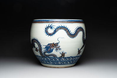 A pair of Chinese blue, white and copper-red 'dragon' fish bowls, Qianlong