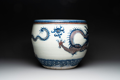 A pair of Chinese blue, white and copper-red 'dragon' fish bowls, Qianlong