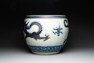 A pair of Chinese blue, white and copper-red 'dragon' fish bowls, Qianlong