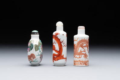 Three Chinese famille rose and iron-red 'Buddhist lion' and 'dragon' snuff bottles, 19th C.