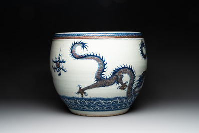 A pair of Chinese blue, white and copper-red 'dragon' fish bowls, Qianlong