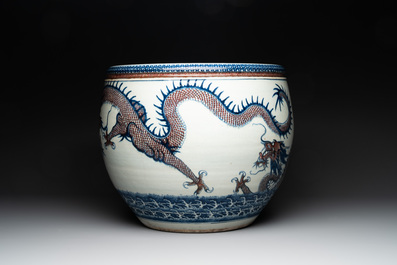 A pair of Chinese blue, white and copper-red 'dragon' fish bowls, Qianlong