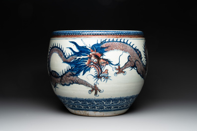 A pair of Chinese blue, white and copper-red 'dragon' fish bowls, Qianlong