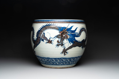 A pair of Chinese blue, white and copper-red 'dragon' fish bowls, Qianlong