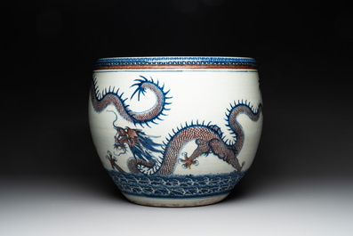 A pair of Chinese blue, white and copper-red 'dragon' fish bowls, Qianlong