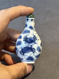 Two Chinese blue, white and copper-red snuff bottles and a blue and white 'crab' snuff bottle, Chenghua and Qianlong mark, 19th C.