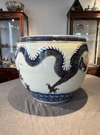 A pair of Chinese blue, white and copper-red 'dragon' fish bowls, Qianlong