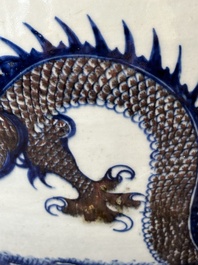 A pair of Chinese blue, white and copper-red 'dragon' fish bowls, Qianlong